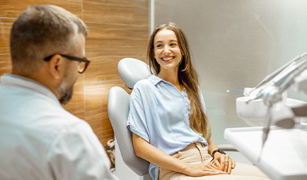 Female patient smiling at dentist at dental appointment